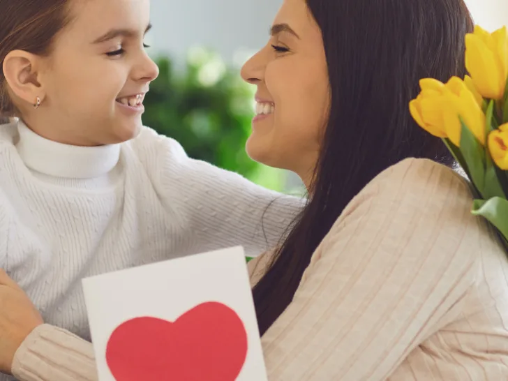 A daughter giving her other a card for mother's day