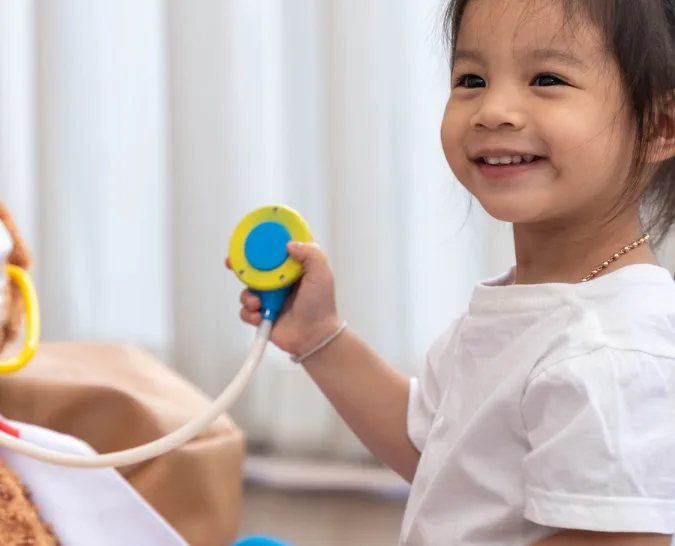 A-smiling-child-playing-pretend-play-doctor-by-herself