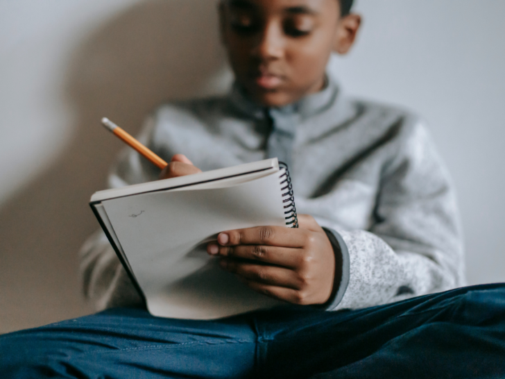 a-young-black-boy-journaling