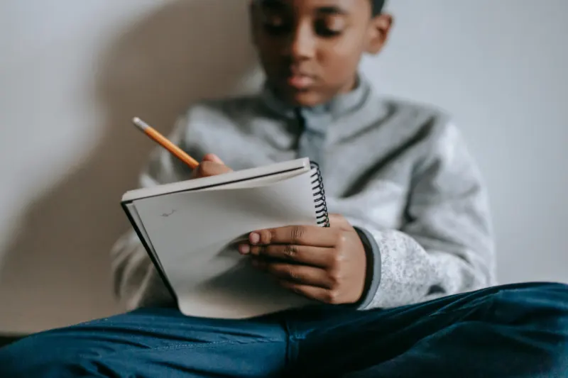 a-young-black-boy-journaling