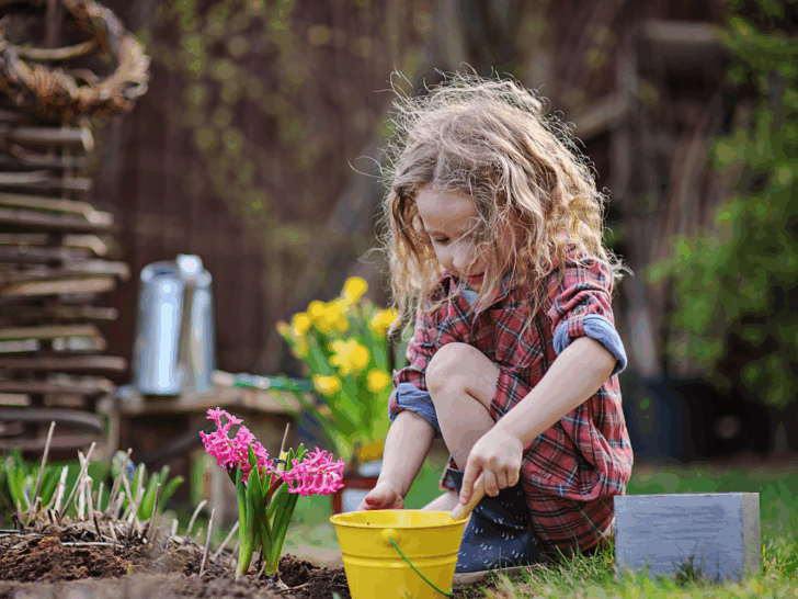 a young child planting flowers